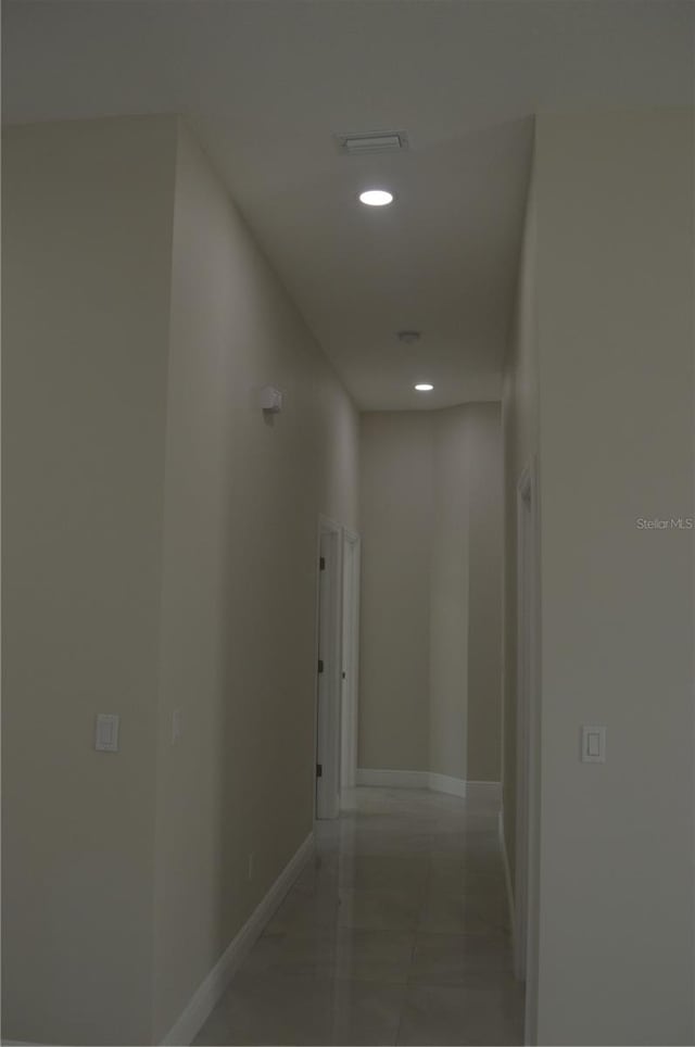 hall featuring light tile floors