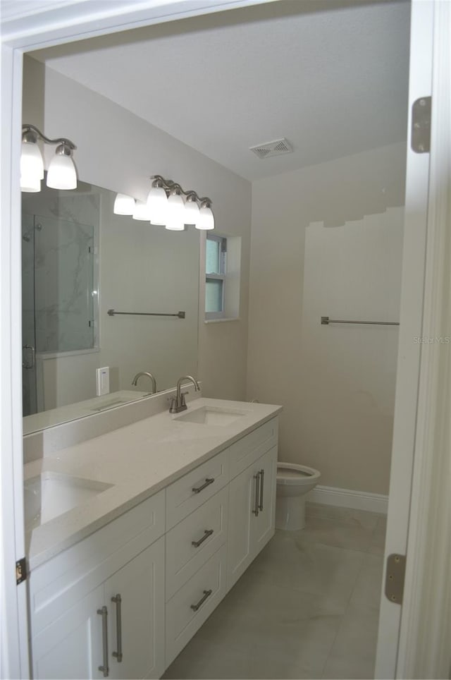 bathroom featuring toilet, dual bowl vanity, and tile flooring