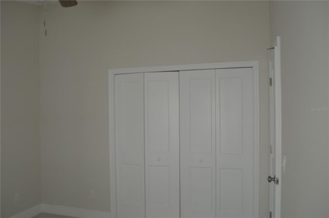 unfurnished bedroom with a closet and ceiling fan