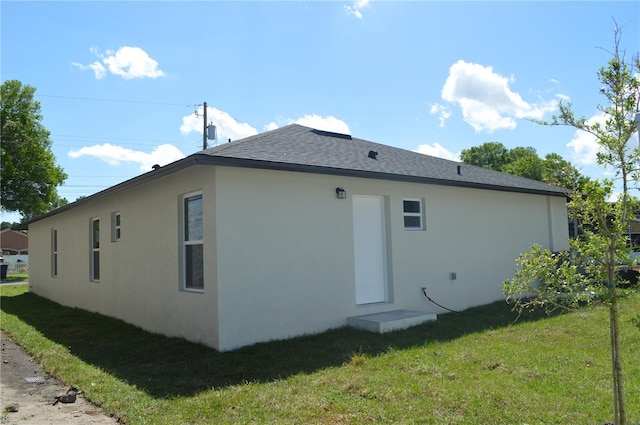 rear view of property featuring a yard