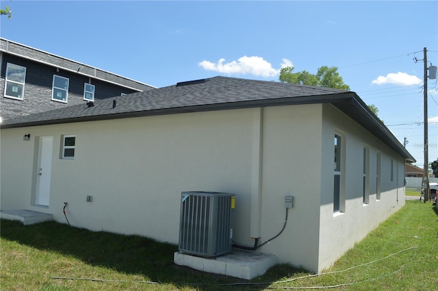 view of home's exterior featuring a yard and central air condition unit