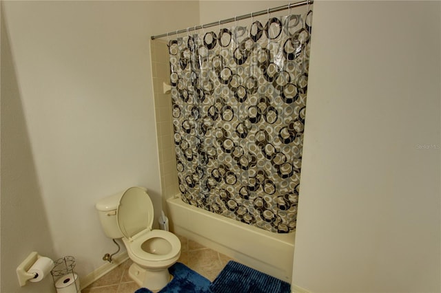 bathroom with shower / bath combo, toilet, and tile floors