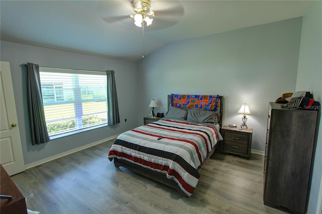 bedroom featuring vaulted ceiling, ceiling fan, and hardwood / wood-style flooring