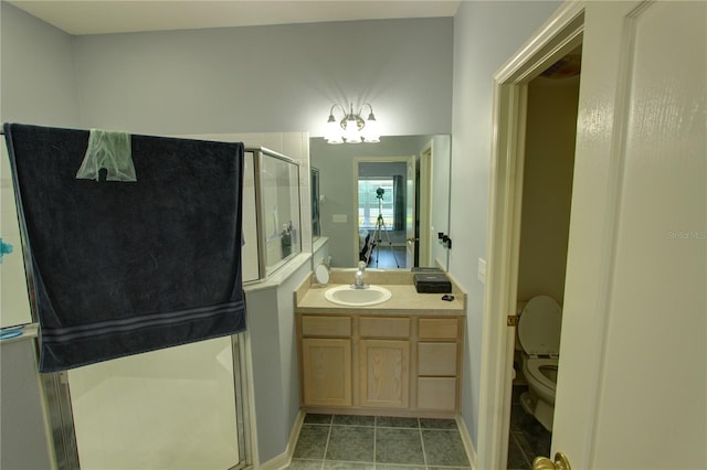 bathroom featuring an enclosed shower, tile floors, oversized vanity, and toilet