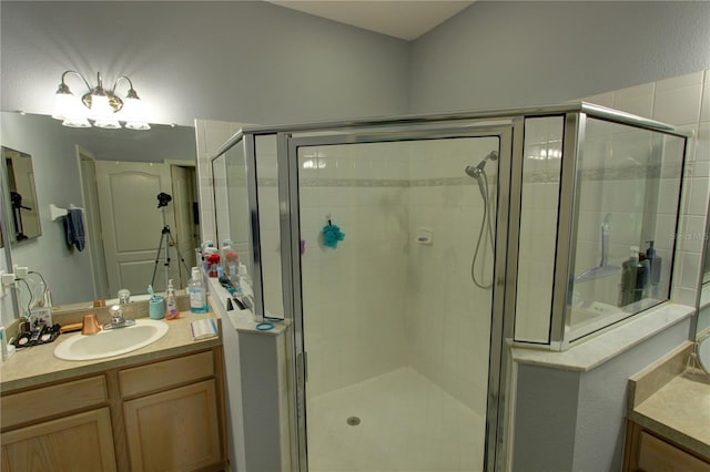 bathroom with a shower with shower door and oversized vanity