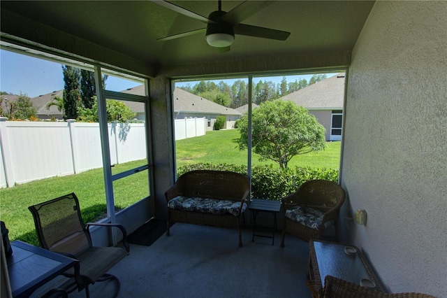 sunroom featuring ceiling fan