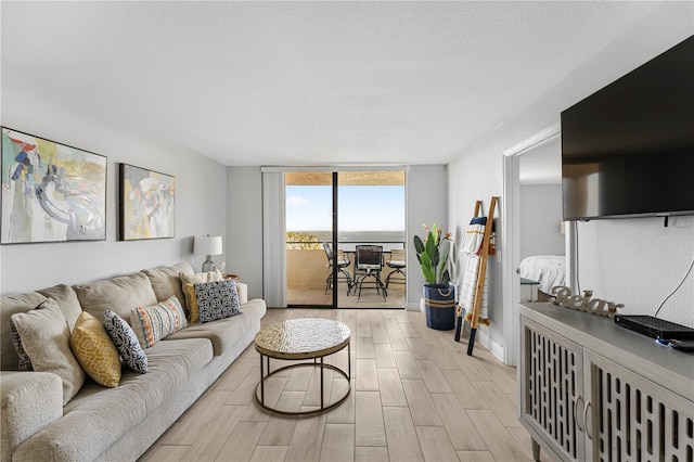 living room with floor to ceiling windows and a textured ceiling