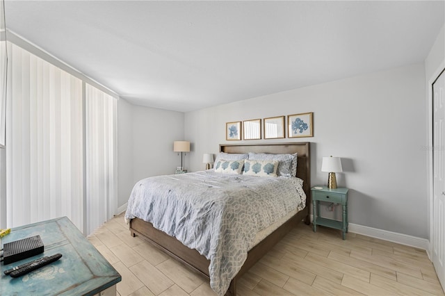 bedroom with wood finish floors and baseboards