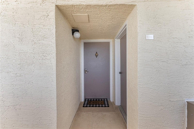 doorway to property featuring stucco siding