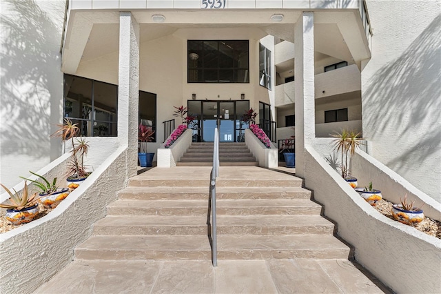 entrance to property featuring stucco siding