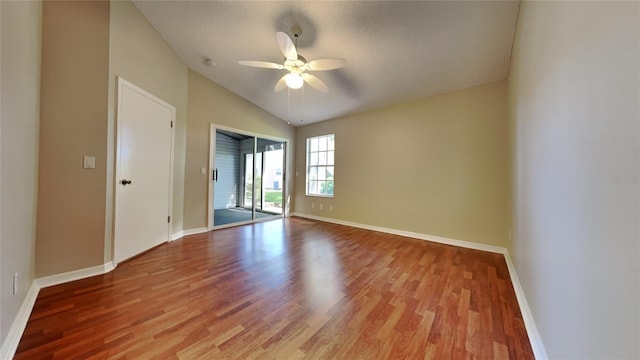 empty room with lofted ceiling, light hardwood / wood-style floors, and ceiling fan