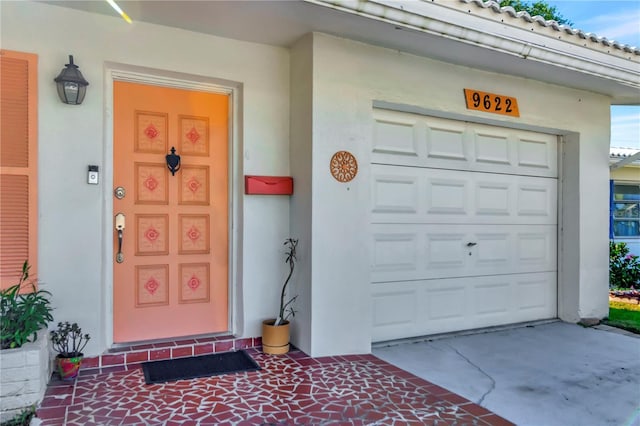 view of exterior entry with a garage