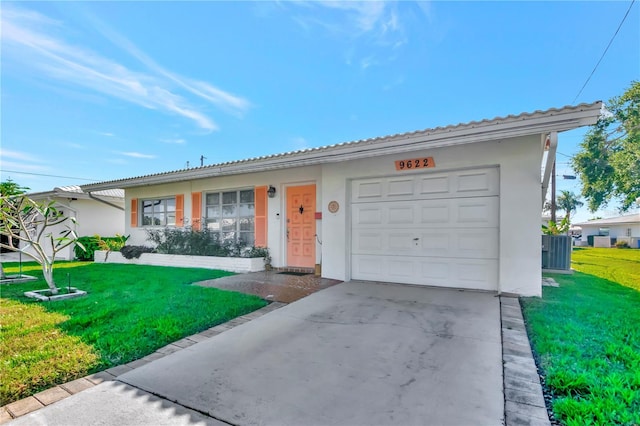 ranch-style house featuring a front lawn and a garage