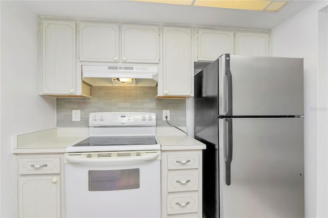 kitchen featuring white cabinetry, backsplash, stainless steel fridge, and white electric range