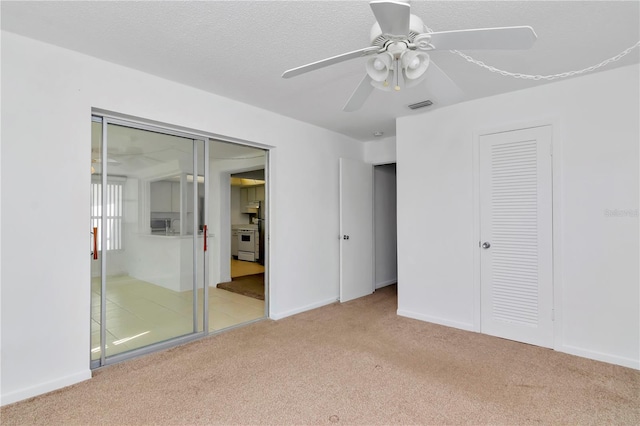 unfurnished bedroom with light carpet and ceiling fan