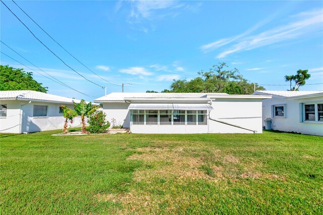 rear view of house with a yard