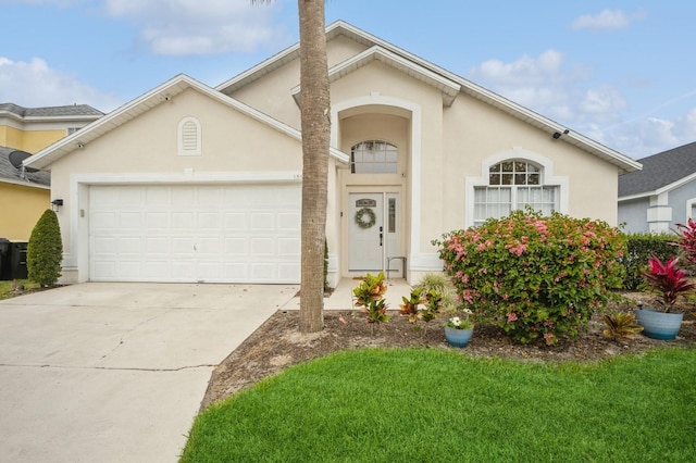 view of front facade featuring a front yard and a garage