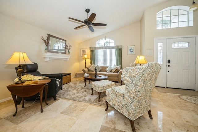 tiled living room featuring ceiling fan, high vaulted ceiling, and a wealth of natural light