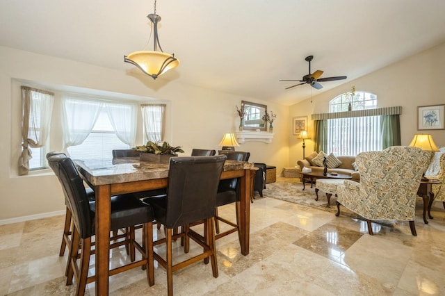 tiled dining room featuring vaulted ceiling and ceiling fan