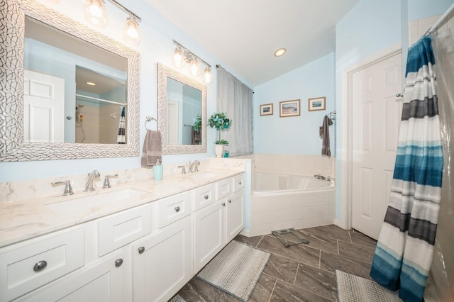 bathroom with tile floors, a relaxing tiled bath, dual vanity, and lofted ceiling