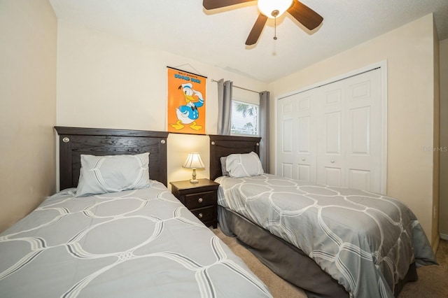 carpeted bedroom featuring a closet and ceiling fan