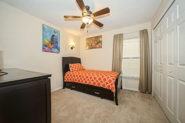 carpeted bedroom featuring a closet and ceiling fan