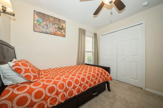 bedroom with a closet, light carpet, and ceiling fan