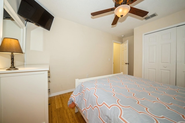 unfurnished bedroom with a closet, ceiling fan, and light wood-type flooring