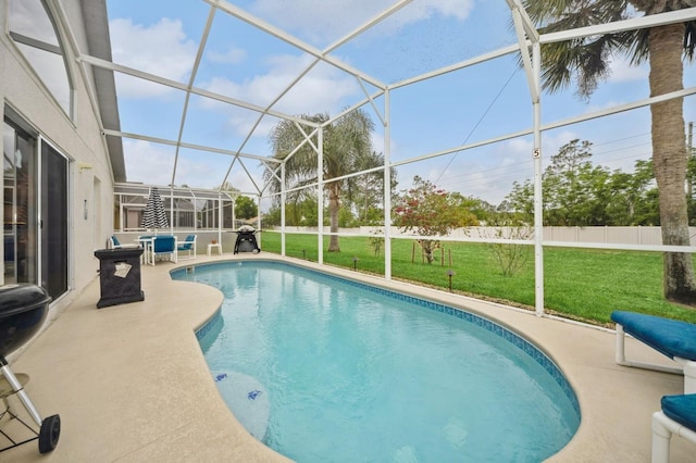 view of swimming pool with a lanai, a yard, and a patio area