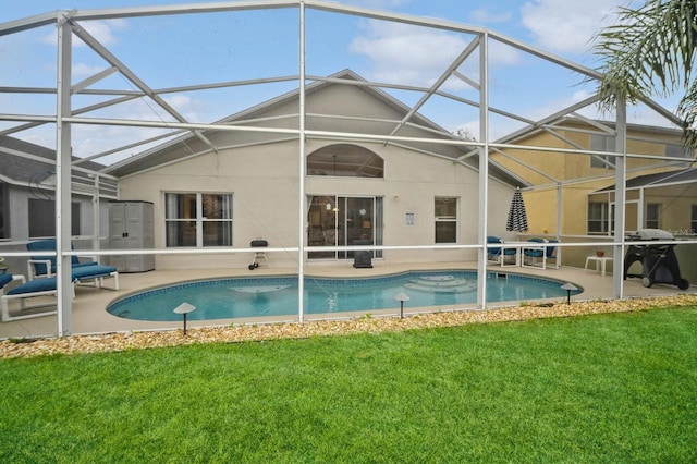 view of swimming pool with glass enclosure, a yard, and a patio area