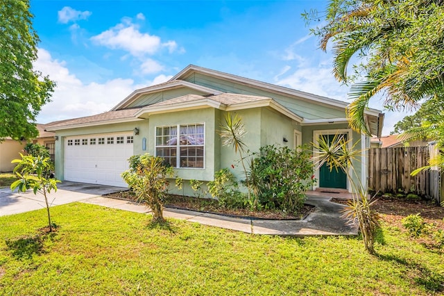 view of front of home with a front yard and a garage