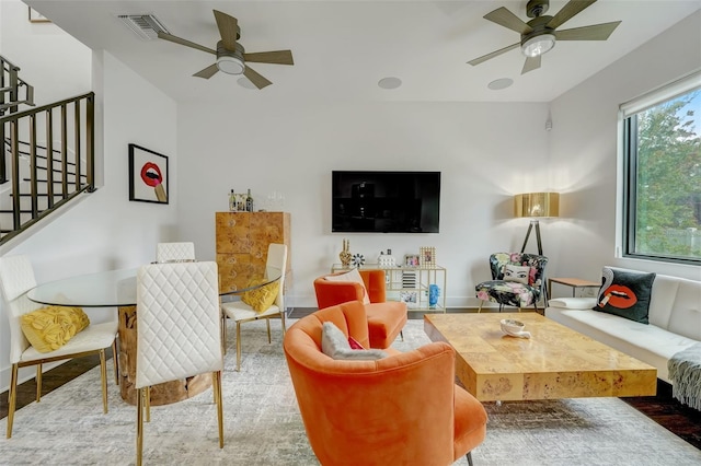 living room featuring ceiling fan and light hardwood / wood-style flooring