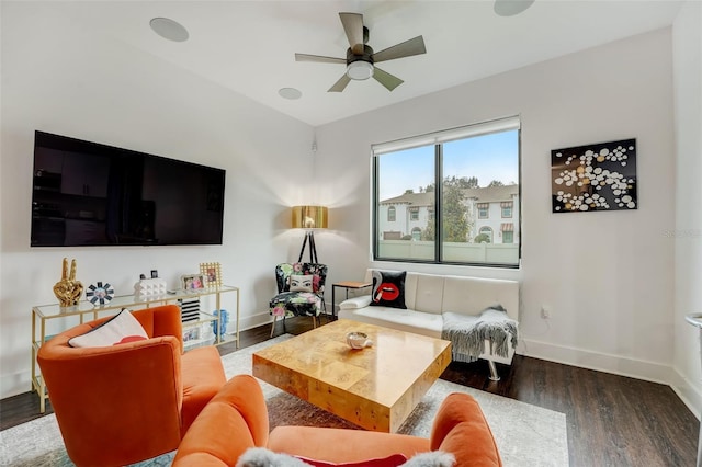 living room with ceiling fan and dark wood-type flooring