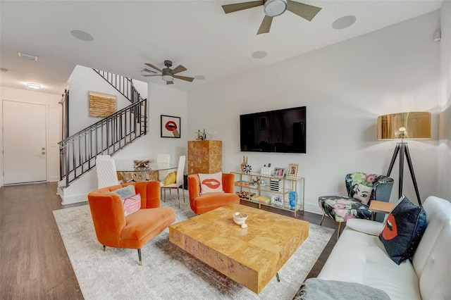 living room with ceiling fan and wood-type flooring