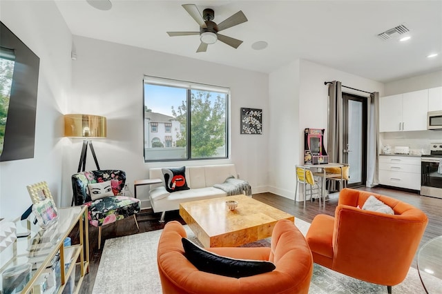 living area featuring ceiling fan and hardwood / wood-style floors