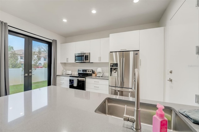 kitchen featuring white cabinets, stainless steel appliances, and french doors