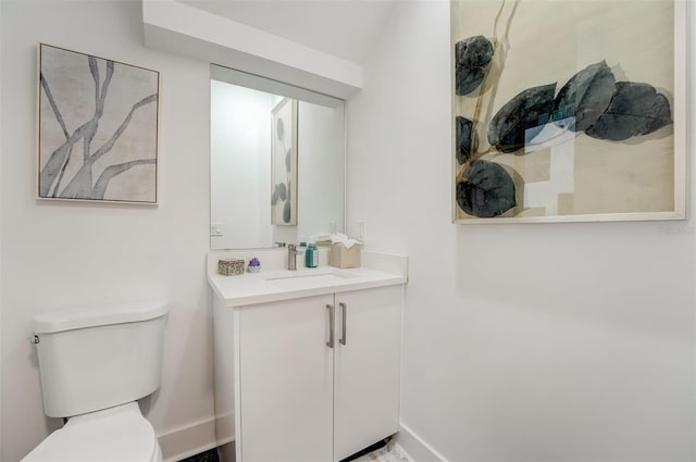 bathroom featuring toilet and vanity