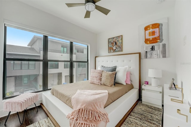 bedroom with dark hardwood / wood-style flooring and ceiling fan