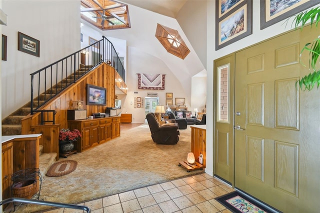 entryway featuring a high ceiling and light tile flooring