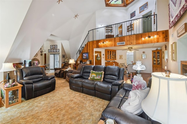 living room with carpet, ceiling fan, and high vaulted ceiling