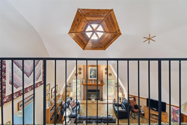 interior details with a skylight and a brick fireplace