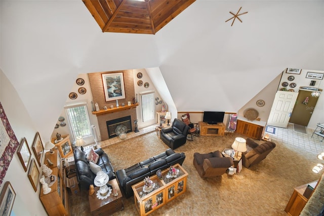 living room featuring brick wall, high vaulted ceiling, and carpet floors