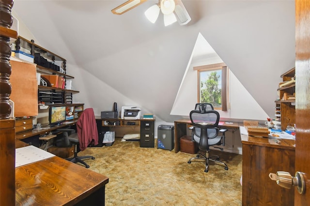 carpeted office space featuring vaulted ceiling and ceiling fan