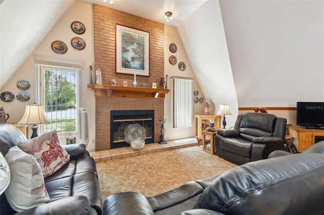 living room with a fireplace, vaulted ceiling, and brick wall