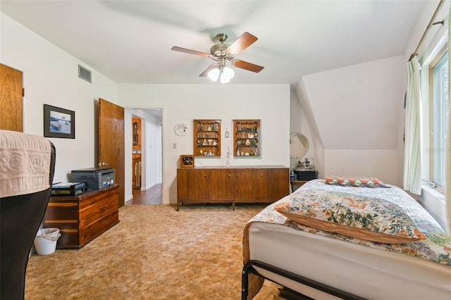 bedroom with vaulted ceiling, ceiling fan, and light carpet