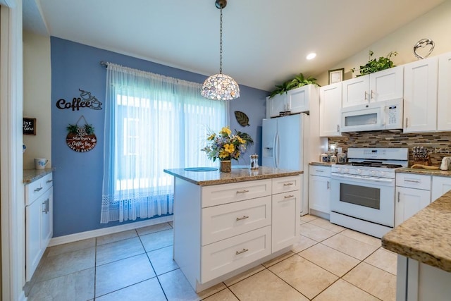 kitchen with hanging light fixtures, backsplash, white appliances, light tile floors, and white cabinets