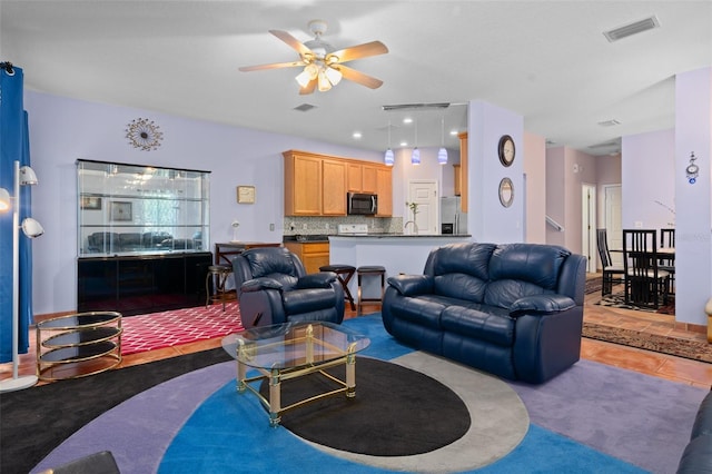 living room featuring ceiling fan and tile flooring