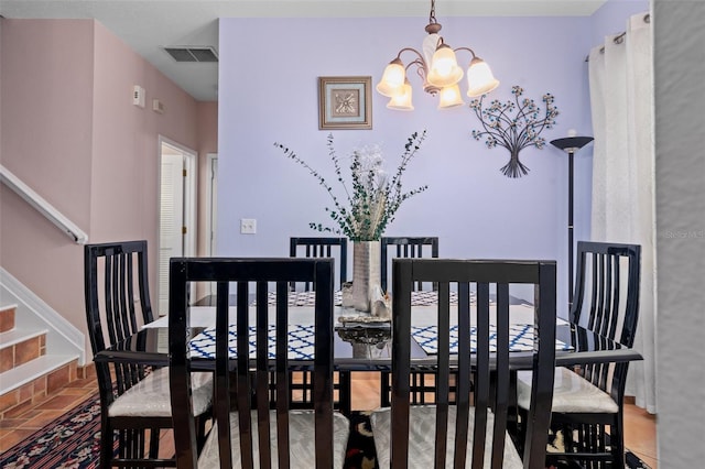 dining room featuring an inviting chandelier and tile floors