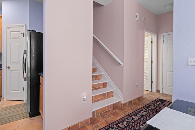 staircase with light tile flooring