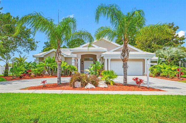 view of front facade featuring a front yard and a garage